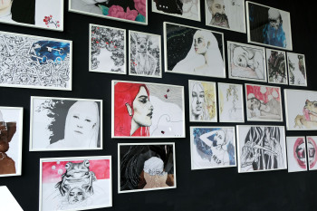 Eine Wand an der verschiedene Bilder angebracht sind.