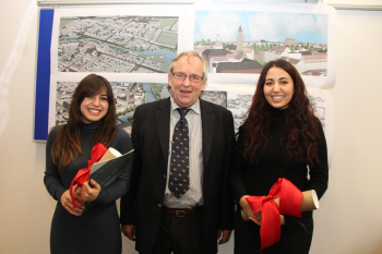 Zwei Studentinnen mit ihrem Professor nach der Präsentation ihrer Arbeit