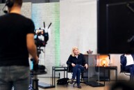 Eine Frau sitzt auf einem Stuhl.