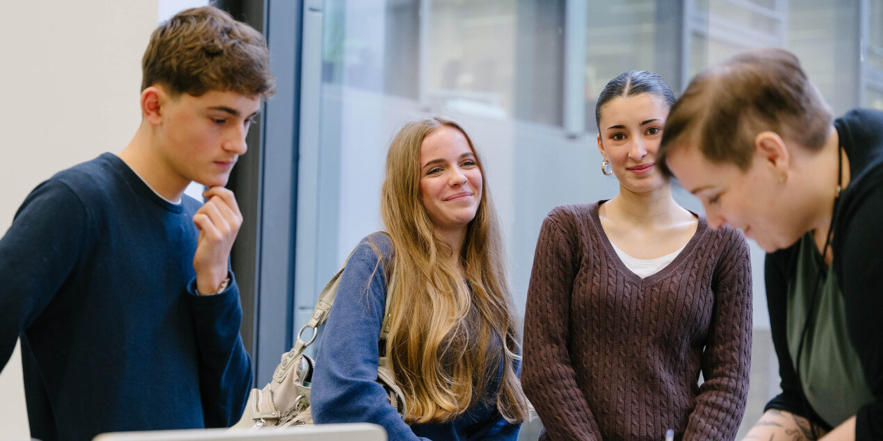 Vier Personen in einem Hörsaal