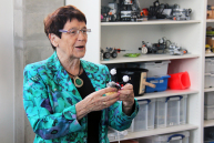 Prof. Rita Süssmuth hält einen Roboter in der Hand.