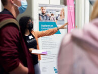 Eine Frau gestikuliert vor Publikum