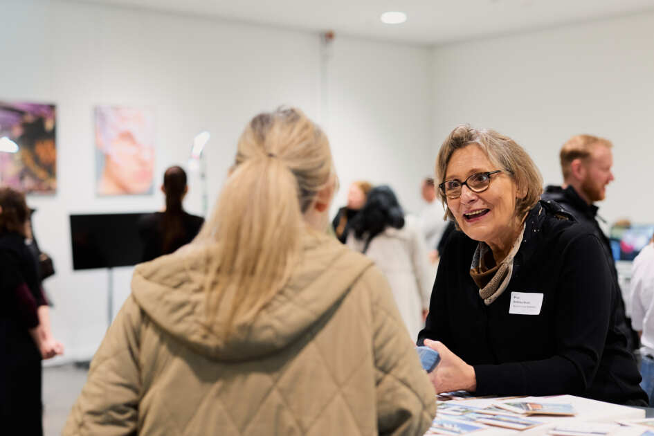Foto: Eine Person lässt sich am Stand des Architekturstudiengangs des Campus Minden beraten