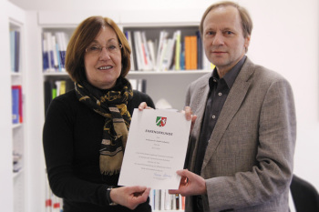 Professorin Dr. Beate Rennen-Allhoff überreicht Professor Dr. Detlef Deßaules die Ehrenurkunde.