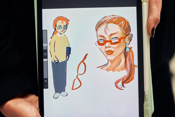 Eine gezeichnete Sozialarbeiterin mit roten Haaren in einem Zopf und einer roten Brille